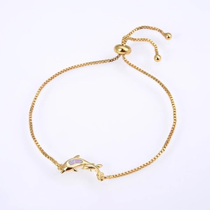 Detail of adjustable gold box chain bracelet with purple opal inlay dolphin pendant