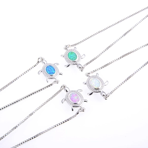 Detailed macro of turtle pendants with opal stones and zircon stones in four vibrant colors