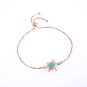 Detailed view of adjustable rose gold turtle bracelet with blue opal and box chain