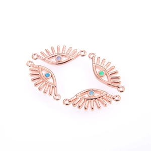 Detail of rose gold evil eye connectors with opal inlay and dual rings for DIY jewelry