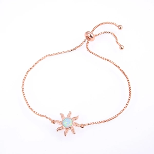 Detail of rose gold sunburst bracelet with white opal and adjustable bolo slider clasp