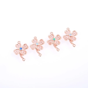 Macro shot of rose gold clover connectors with opal centers and white zircon stones