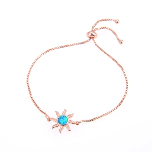 Detail of rose gold sunflower bracelet with blue opal stone and adjustable box chain