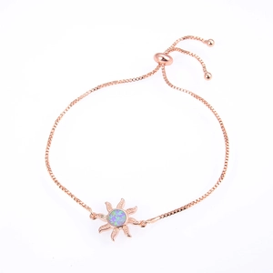 Detail of adjustable rose gold bolo bracelet with opal sun charm and box chain slide