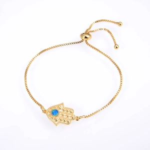Adjustable golden box chain bracelet with Hamsa Hand charm and blue gemstone inlay
