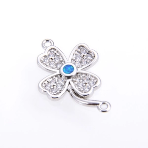 Silver four-leaf clover connector with white crystals and central blue opal stone