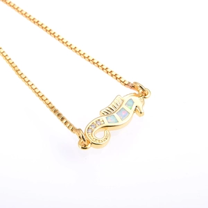 Detail der Seepferdchen-Halskette mit weißem Opal und Zirkonia-Schwanz in Gold-Finish