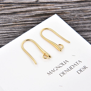 Detailed view of gold plated U-shaped ear wires on a display card for DIY jewelry making