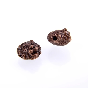 Macro-detail van antieke bronzen leeuwenkopkralen voor DIY-sieraden met een nauwkeurig rijggat