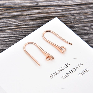 Close-up of rose gold U-shaped earring hooks on a display card for DIY jewelry making