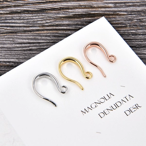 U-shaped earring hooks in gold, silver, and rose gold finishes on a display card
