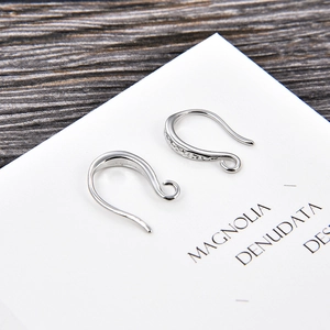 Detail view of silver DIY earring hooks with sparkling zircon stones for jewelry making