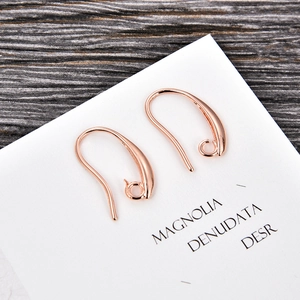 Close-up of rose gold U-shaped DIY earring hooks on display card for jewelry making