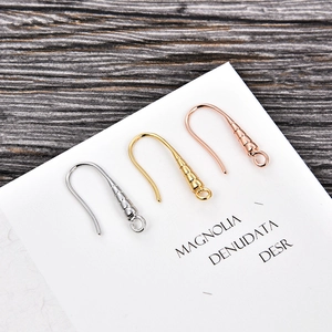 Detail of DIY fish hook earrings in gold, silver, and rose gold on a card display