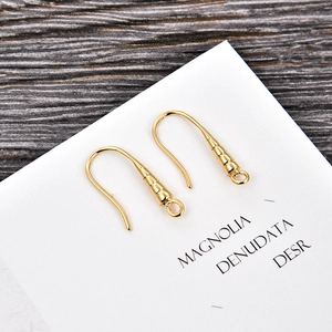 Detail of gold-plated U-shaped French earring hooks with spiral texture for DIY jewelry