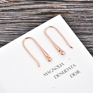 Close-up of U-shaped S925 rose gold earring hooks for DIY jewelry making accessories