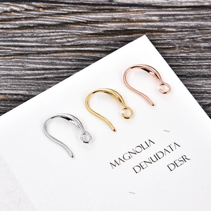Macro shot of U-shape earring hooks in silver, gold and rose gold for DIY jewelry making