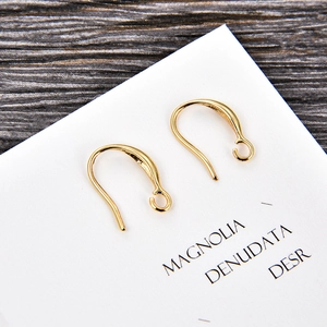 Macro shot of gold-plated U-shaped earring hooks with closed loop for DIY jewelry making