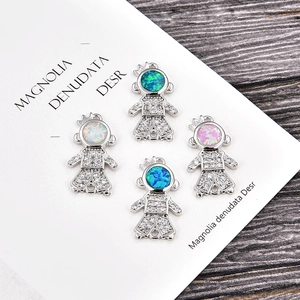 Macro view of cartoon girl connectors with opal stones for DIY jewelry making
