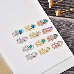 Detailed view of opal boy and girl charms in gold, silver, and rose gold plating