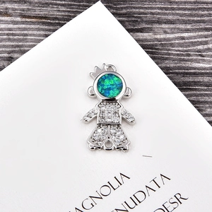 Macro view of silver stickman pendant with fire opal head and sparkling zircon pavé
