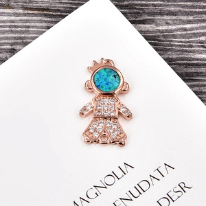 Macro detail of rose gold little prince pendant with opal head and zircon inlay