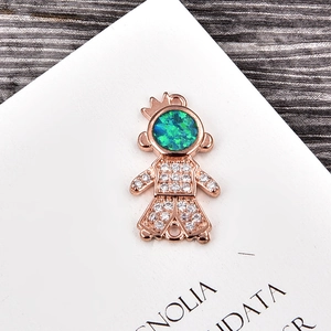 Macro detail of rose gold doll pendant featuring green opal and sparkling zircon micro-paving
