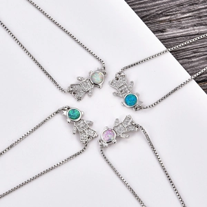 Detail of cute astronaut bracelets with colorful opal heads and adjustable silver chains