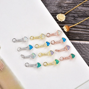 Détails macro de pendentifs en forme de cœur avec opale en finitions or, argent et rose