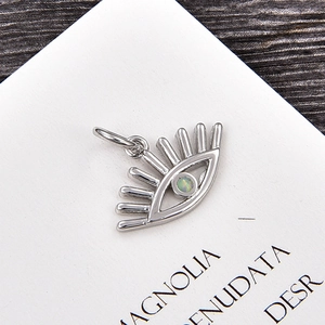 Vista detallada de colgante ojo turco de plata con opalo verde y diseño de pestañas