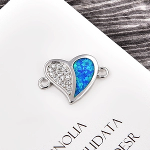 Detailed macro of heart jewelry connector with blue fire opal and pavé cubic zirconia