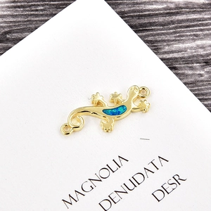 Detail of gold gecko charm with blue opal stone and dual rings for DIY jewelry