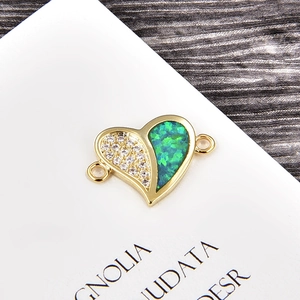 Close-up of heart charm with opal inlay and cubic zirconia stones for DIY bracelet
