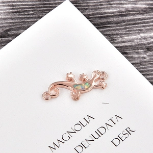 Detail of rose gold gecko connector with opal stone for DIY jewelry making