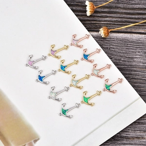 Detail of anchor charms with colorful opal inlays and various plating for DIY jewelry