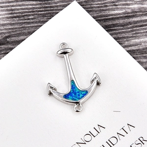 Detail view of anchor-shaped link pendant with blue opal inlay for jewelry making