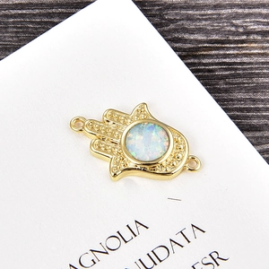 Macro shot of Hamsa hand connector with opal stone for DIY jewelry making
