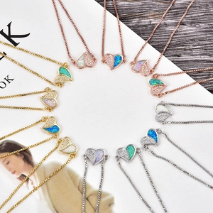 Macro shot of colorful opal heart pendants with cubic zirconia on gold chains