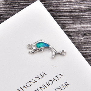Detail of dolphin jewelry connector with blue opal inlay and silver copper finish