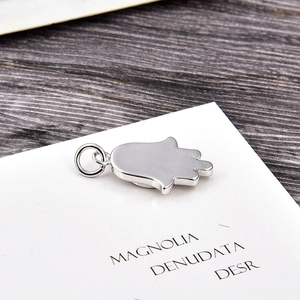Detail view of a silver Hamsa charm with high-polished finish and a hanging ring