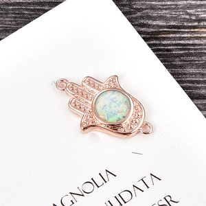 Detail of rose gold Hamsa Hand charm with opal stone for DIY bracelet making