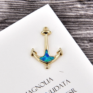 Detail of gold-plated anchor charm connector with blue-green opal for DIY jewelry making