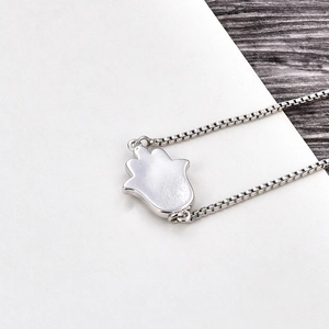 Detail of silver Hamsa Hand pendant on a sturdy box chain with a polished metallic finish