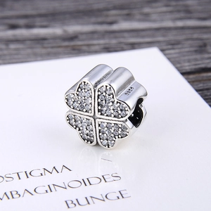 S925 sterling silver four-leaf clover charm with sparkling pavé zircons in close-up shot