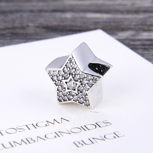 Star-shaped S925 silver charm with pavé cubic zirconia and a central star cutout
