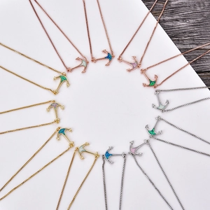 Detailed arrangement of anchor pendants in gold, silver, and opal stone color variants