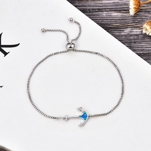 Detail of silver anchor bracelet with blue opal stone and adjustable bolo box chain
