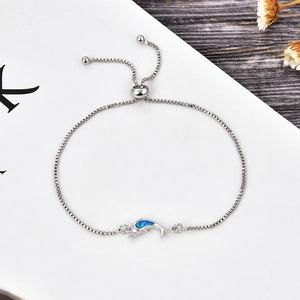 Macro detail of dolphin bracelet with blue opal inlay and adjustable sliding clasp