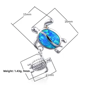 Macro detail of silver turtle pendant with blue-purple opal and precise measurements