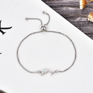 Detail of adjustable dolphin bracelet with white opal inlay and polished box chain